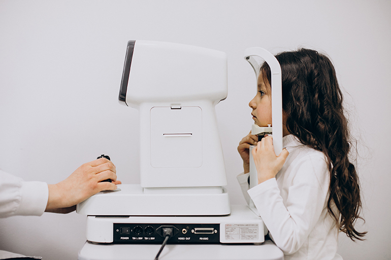 Little girl checking up her sight at ophthalmology center